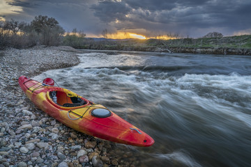 whitewater kayak at sunset