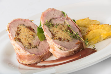 Roasted pork roll stuffed with rice and potatoes with cheese