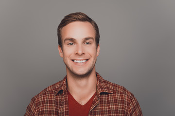 Close up photo of young happy smiling man om gray background
