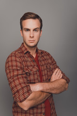 Obraz premium Portrait of strict handsome man posing with crossed hands