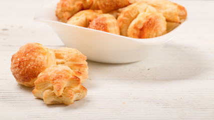 Home-made cookies from puff pastry on a white wooden table