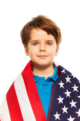 Portrait of little boy wrapped in the USA flag