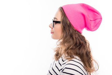 Portrait of young hipster girl in glasses and pink hat