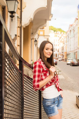 Portrait of beautiful young woman walking on street of city