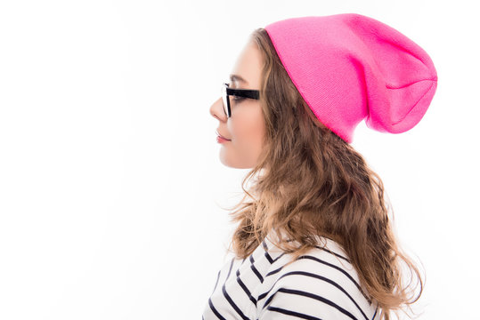 Portrait of young hipster girl in glasses and pink hat