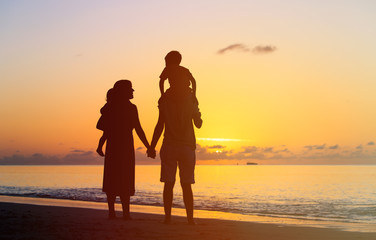 Fototapeta premium happy family with two kids having fun at sunset
