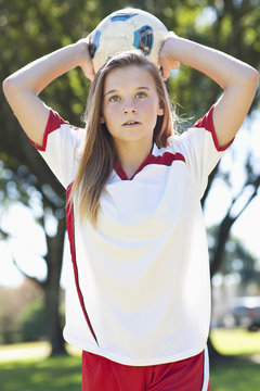 Female soccer player throwing ball