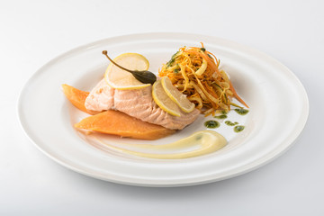 Grilled salmon, mango and salad on a plate