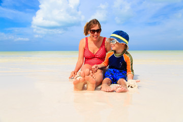 mother and son feet on summer beach