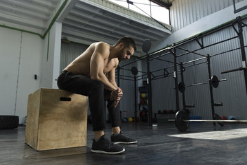 Bodybuilder working out at the gym ,box jumps