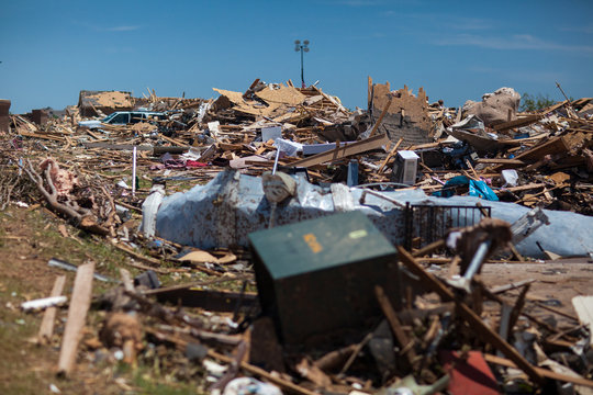 Propane Tanks Lined Up in front of debris from a destructive tornado