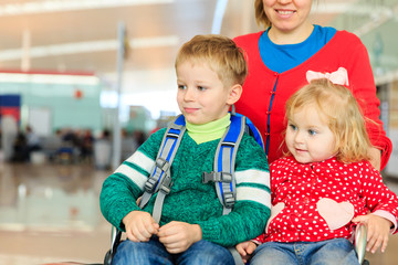 family with two kids travel in the airport