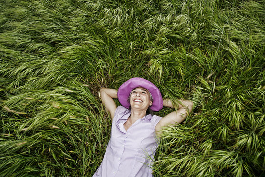 Woman Laying In Tall Grass