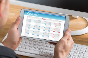 Businessman Using Calendar On Digital Tablet