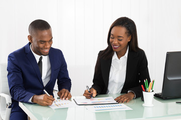 Businesspeople Discussing The Charts And Graphs