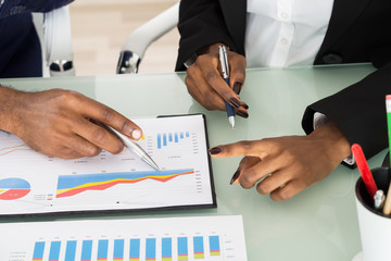 Graphs And Charts Analyzed By Businesspeople