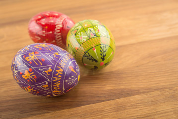 Colorful Easter eggs on wooden background.