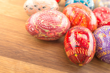 Obraz na płótnie Canvas Colorful Easter eggs on wooden. Holiday background.