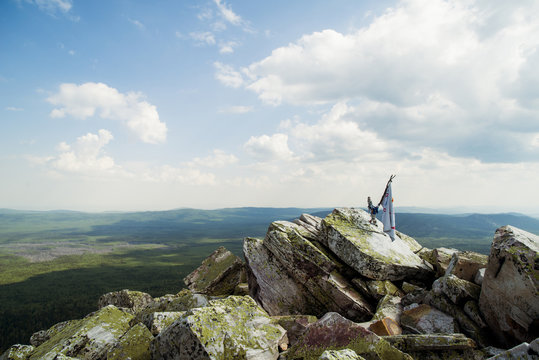 Banner on rocky hilltop in remote landscape