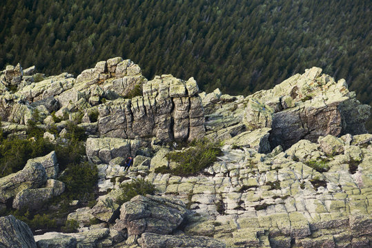 Rocky cliffs over forest treetops in remote landscape