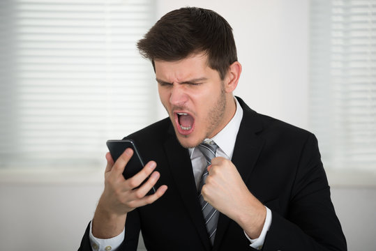 Businessman Screaming On Smart Phone