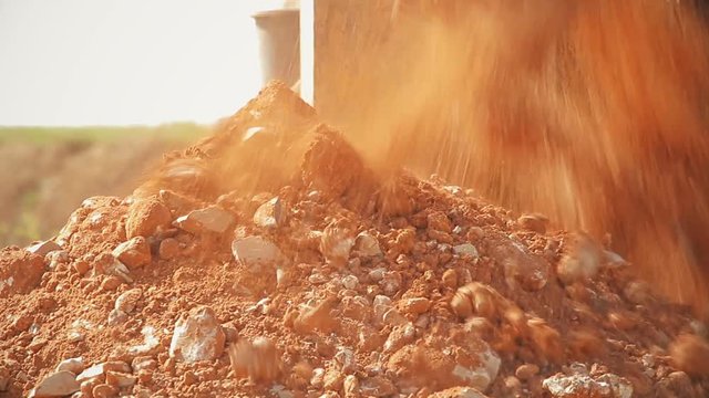 Tractor with a drilling device at a construction site.