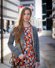 Young professional Caucasian woman walking on city street