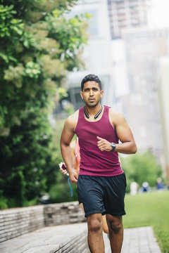 Indian man jogging in city