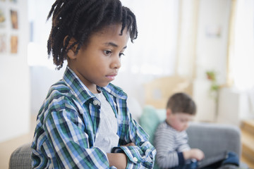 Boy ignoring friend in living room