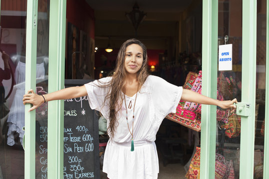 Portrait of female owner opening her shop