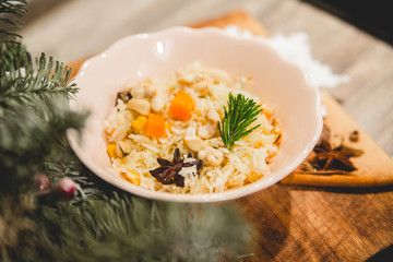 Thistle,dried fruit and rice on Christmas background