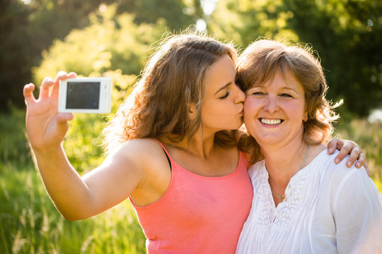 Senior mother with daughter selfie