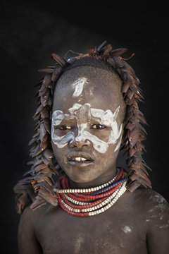 Portrait of teenage girl in tribal face paint