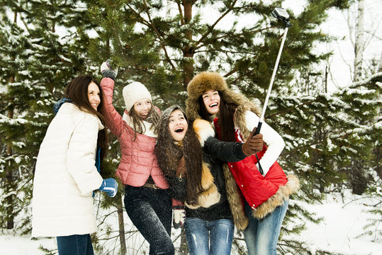 Caucasian girls taking selfie in snow