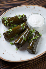 Close-up of traditional eastern dolma served with sour cream
