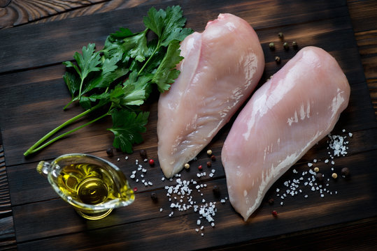 Top view of raw fresh chicken breast fillets with condiments