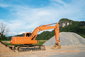 Fototapeta na wymiar Orange excavator loader machine at construction site