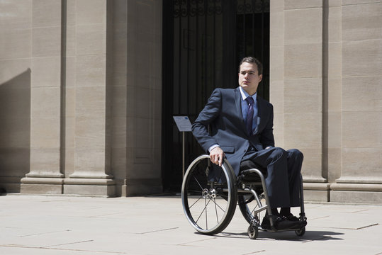 Paraplegic businessman sitting in wheelchair