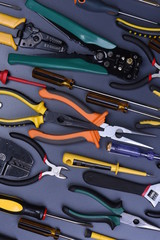 Set of tools to electrical installations on metal background