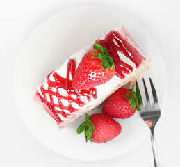 sweet strawberry cake on white plate with fork