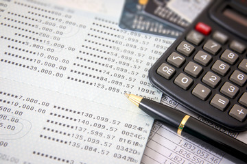 Book bank, credit cards, the calculator, a ball pen. Business finance concept