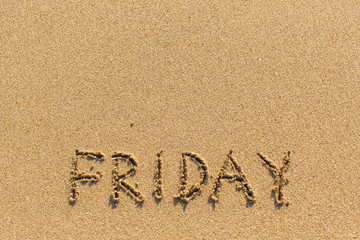 Friday - inscription by hand on yellow beach sand.