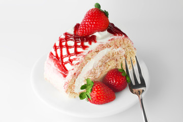 sweet strawberry cake on white plate with fork