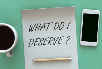 What Do I Deserve, message on paper, smart phone and coffee on table, 3D rendering