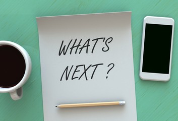 Whats Next, message on paper, smart phone and coffee on table, 3D rendering