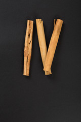 Cinnamon sticks with hand lettering text written on a chalkboard