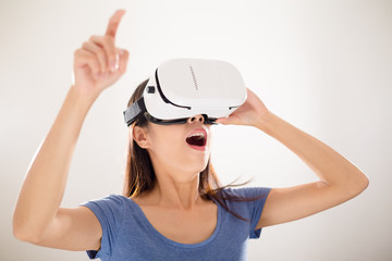 Thrilled woman wearing of vr device