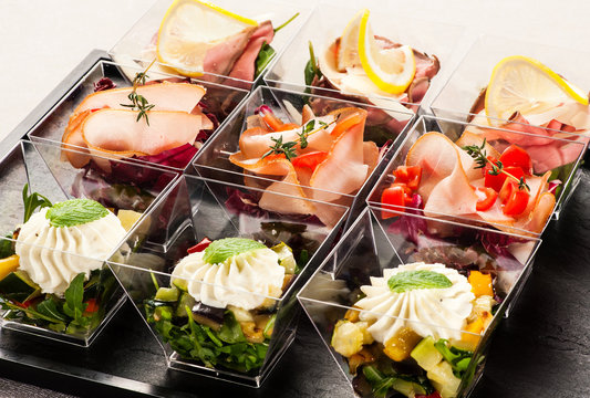 Cute glass containers filled with appetizers