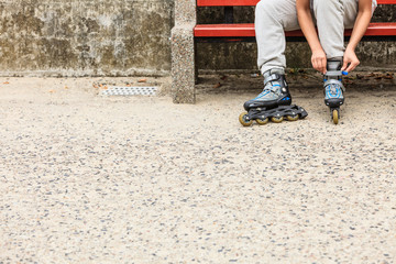 Woman putting on roller skates outdoor.