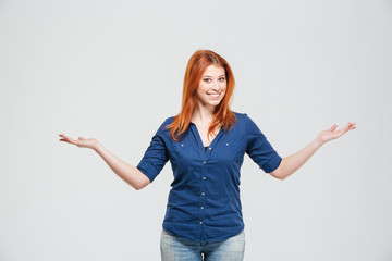 Happy woman holding copyspace on both palms over white background